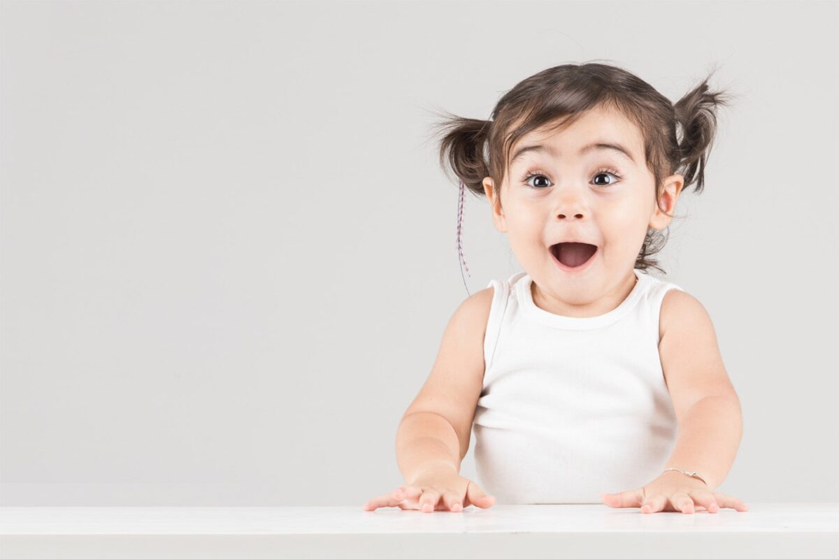 Excited young child with a wide-open mouth