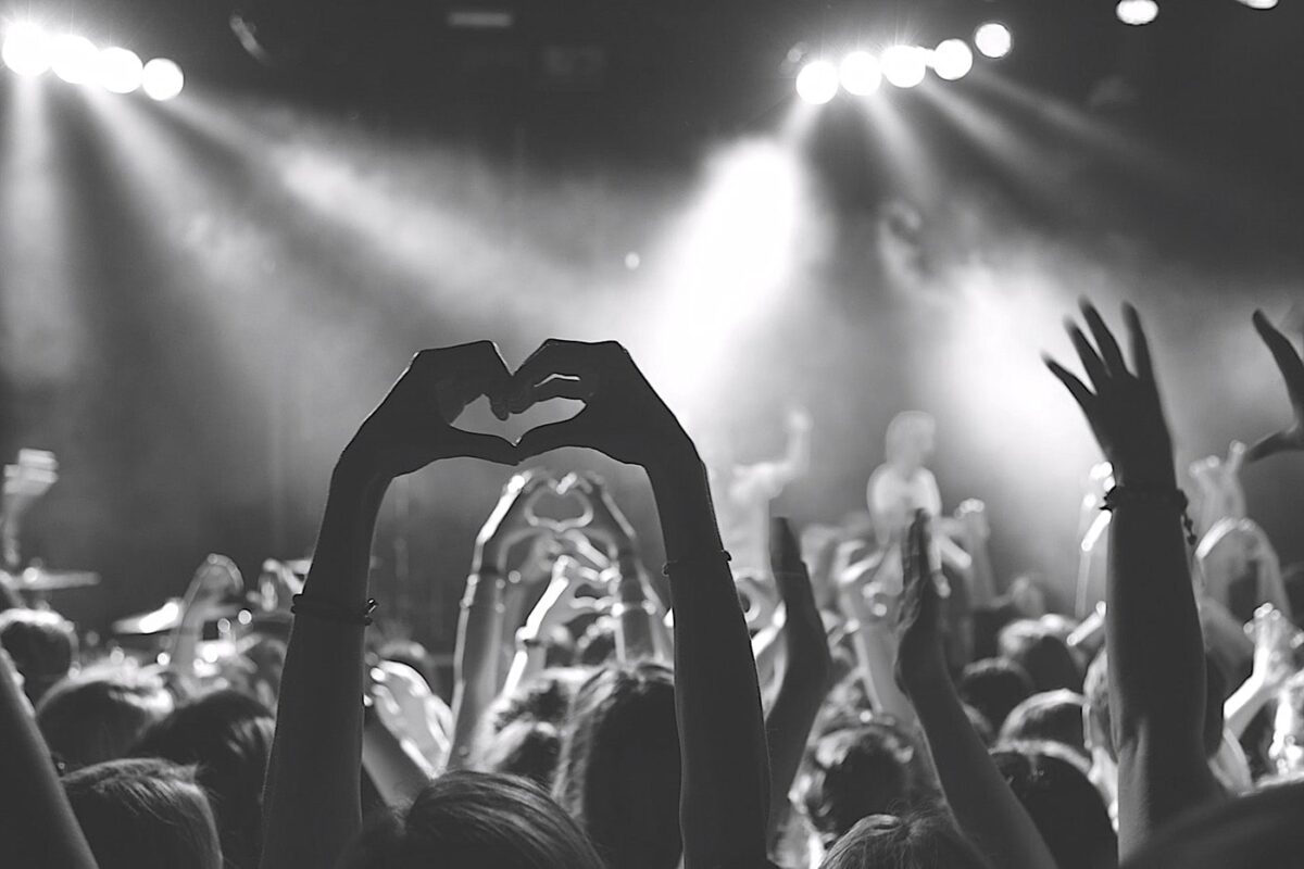Concert crowd making heart shapes with their hands
